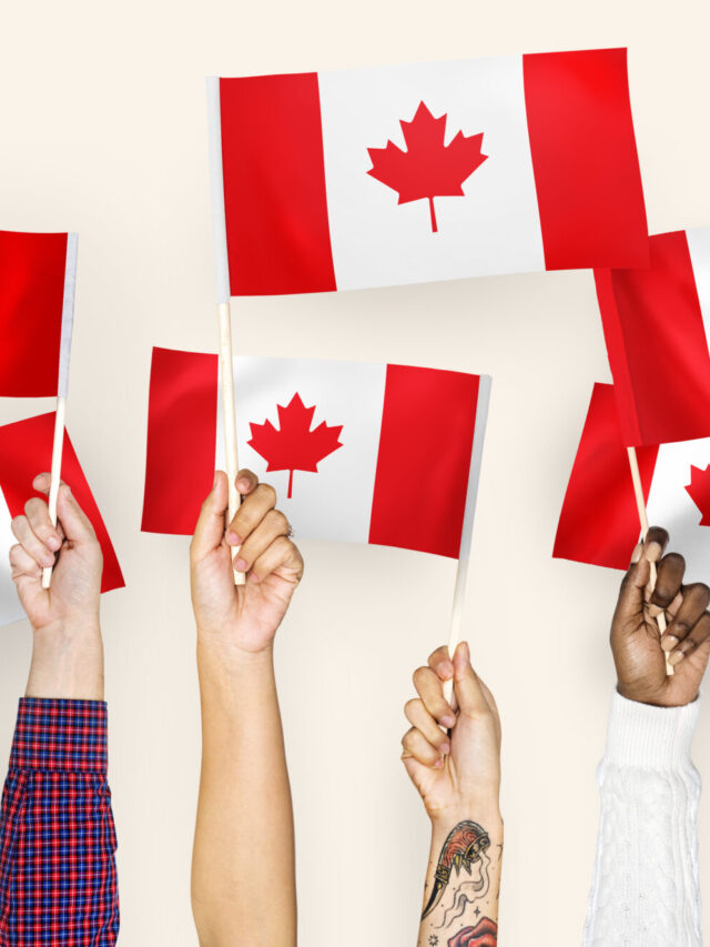 Hands waving flags of Canada